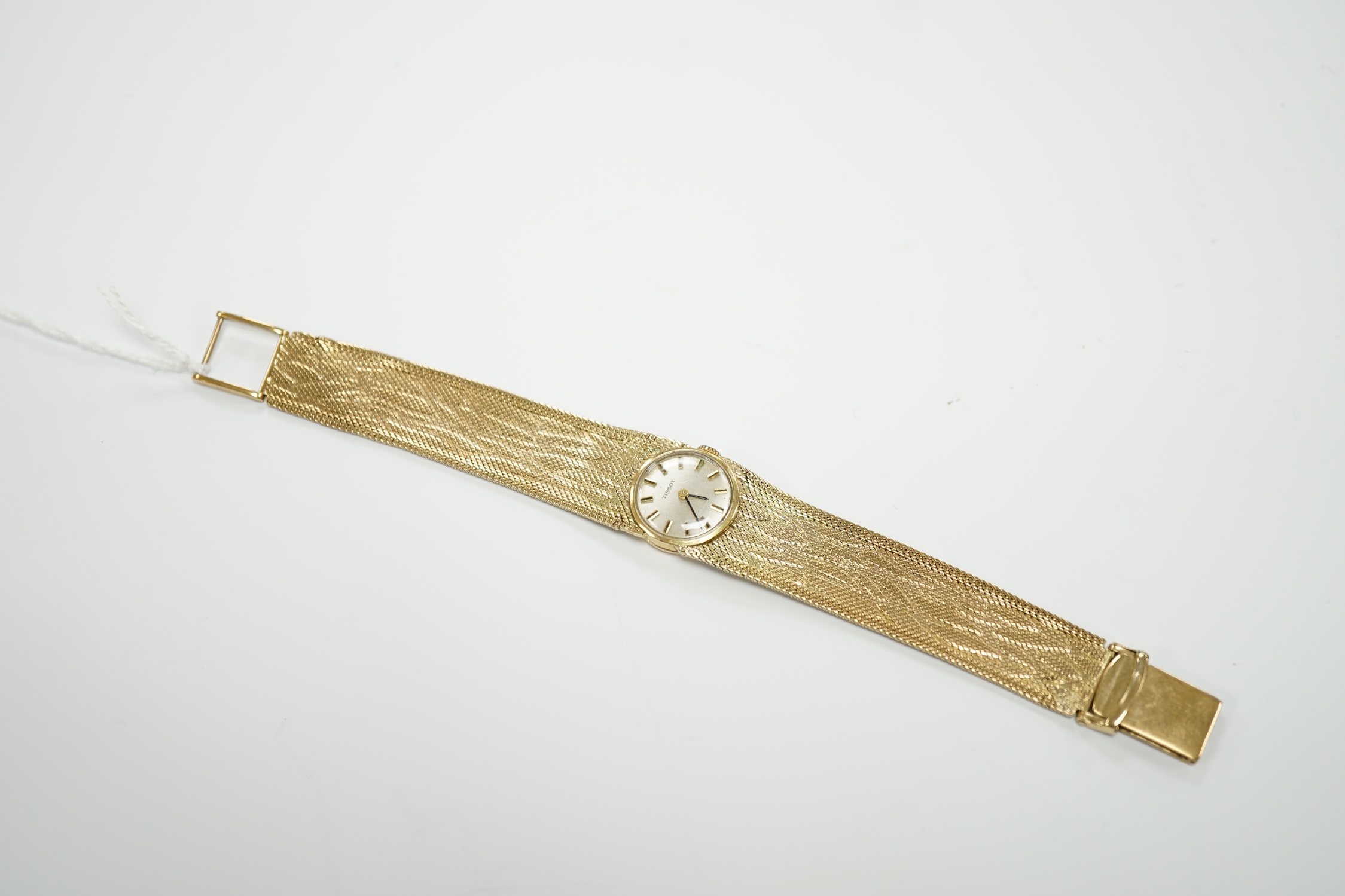 A lady's 9ct gold Tissot manual wind wrist watch, on a 9ct bracelet, 16cm